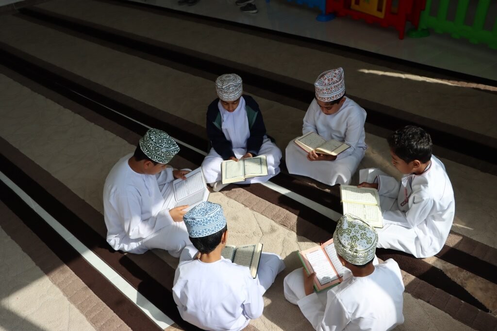 Students sitting together reading the Quran